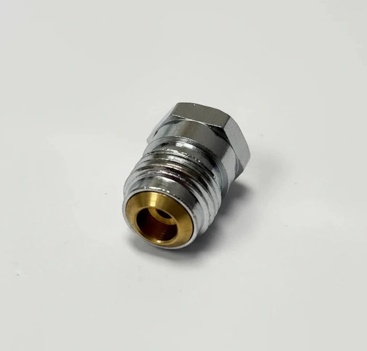A small metal connector fitting with a hexagonal body, silver-toned metal exterior, and a gold-toned inner opening, photographed on a plain light background.