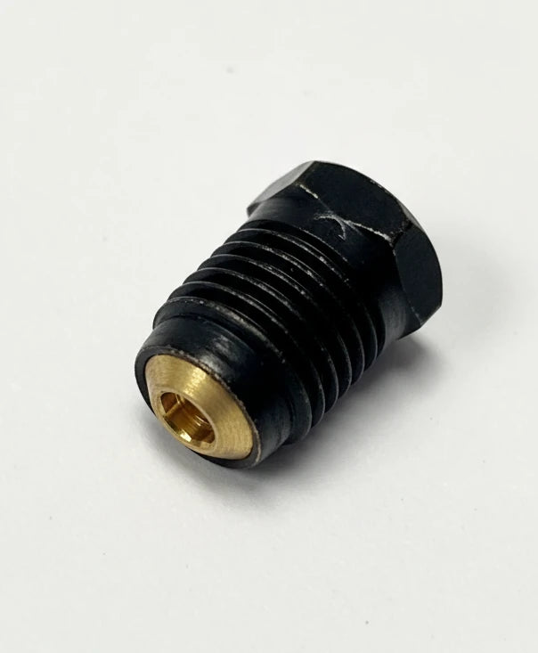 A small black plastic or metal cylindrical component with a gold-colored threaded inner opening, photographed on a plain light gray surface.