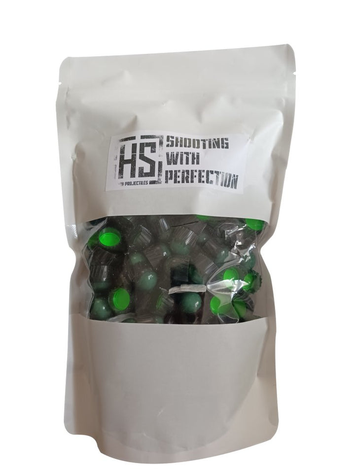 A white stand-up pouch package containing many small green and black capsules, with a printed label reading 'HS Shooting With Perfection' on a plain white background.