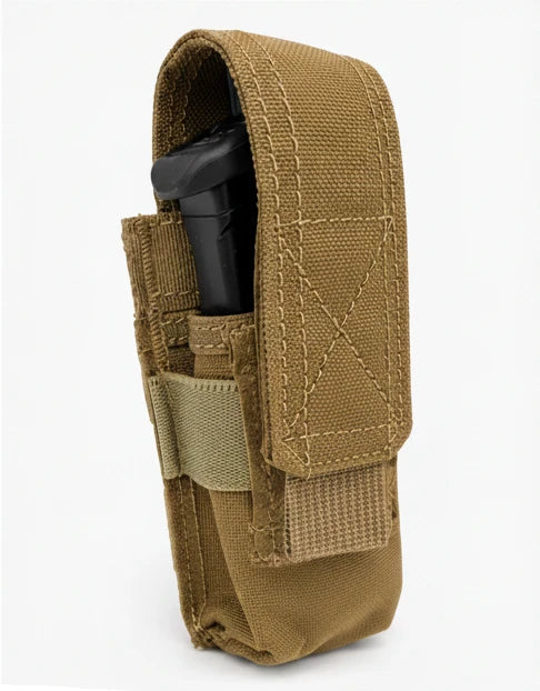 A tan tactical holster made of durable woven fabric, featuring a front hook-and-loop strap and a side pocket holding a black cylindrical item, shown against a plain white background.